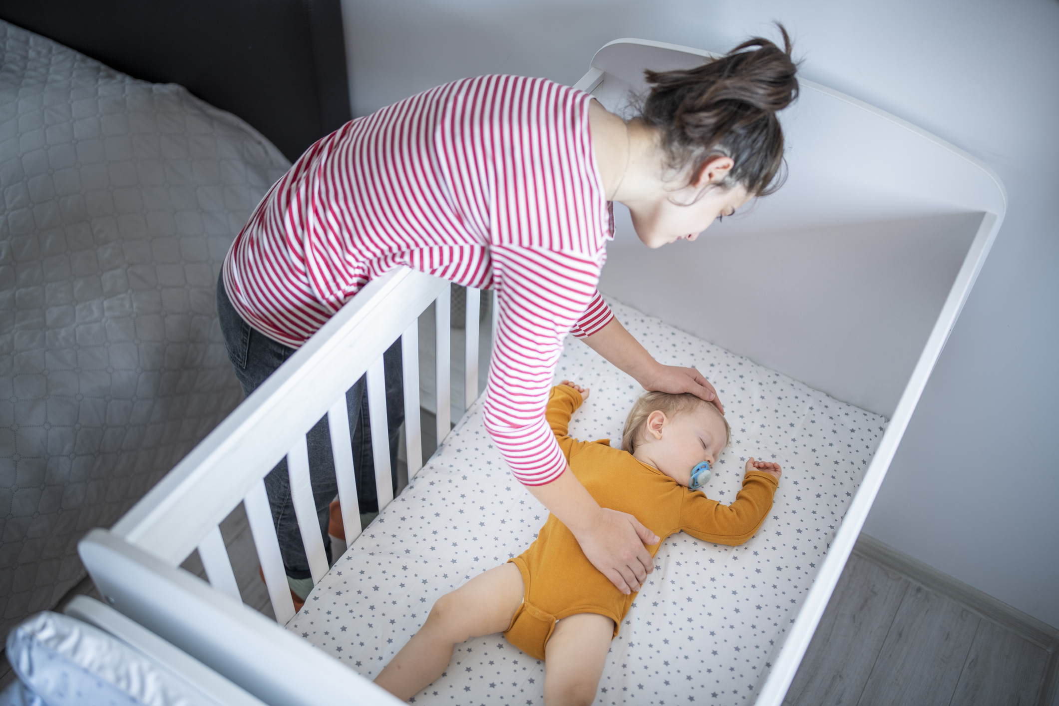 Mother and putting baby to sleep